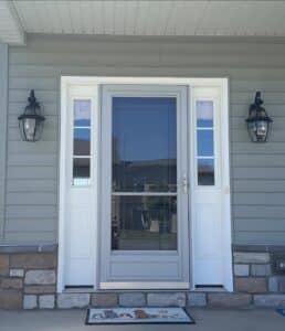 A photo of a front entry of a nice home with a brand newly installed storm door 